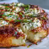 Hot Honey Ricotta Pizza sliced and served with fresh basil leaves, ready to drizzle with spicy honey.