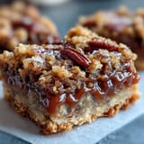 A close-up shows Decadent Sweet and Chewy Turtle Bars with Chocolate and Caramel, where melted chocolate pools over toasted oats and chopped pecans.