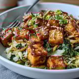 Savory Tofu Egg Roll in a Bowl topped with fresh green onions and sesame seeds, ready to enjoy straight from the skillet.