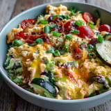 This Scrambled Egg and Veggie Bowl features soft eggs, melty cheddar, and colorful bell peppers served hot.