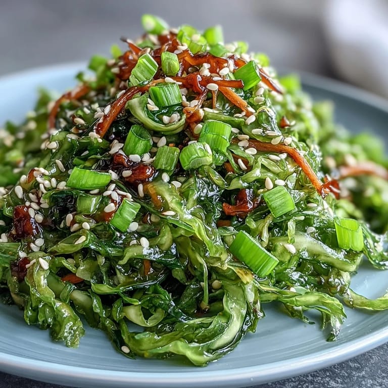 Steam rises from a serving bowl of Hot and Sour Cabbage, showcasing tender-crisp vegetables tossed in a tangy sauce alongside steamed jasmine rice.