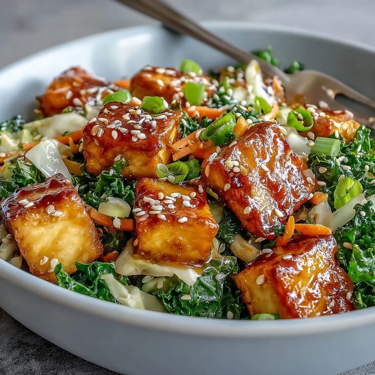Colorful plated Tofu Egg Roll in a Bowl with wilted kale and spinach, garnished with chili flakes for extra kick.